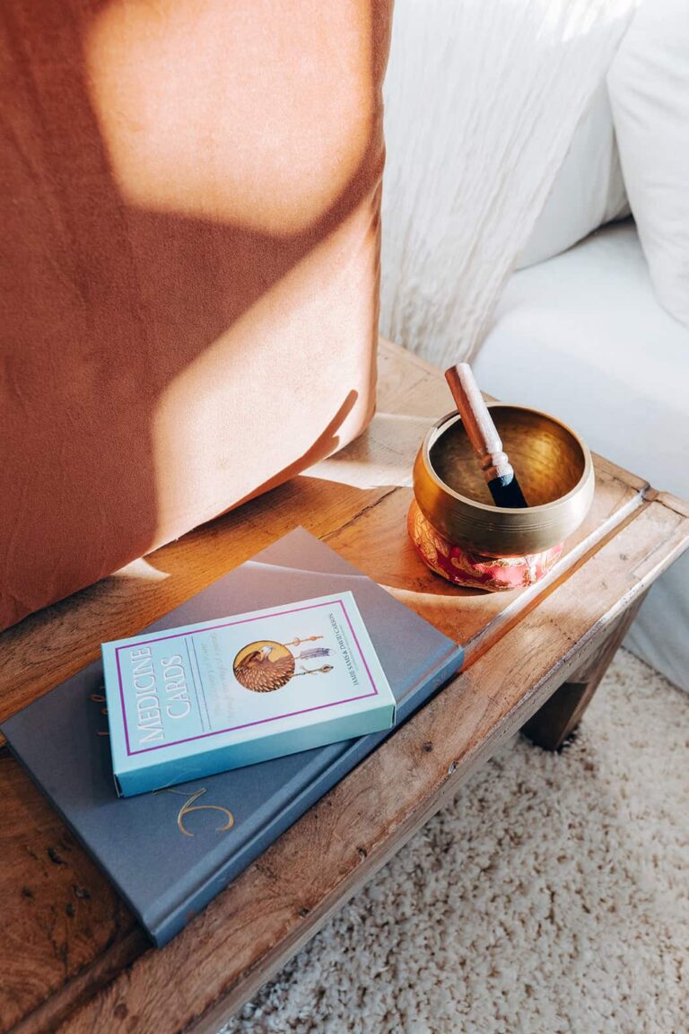 Medicine Cards and Tibetan bowl placed on a wooden table.