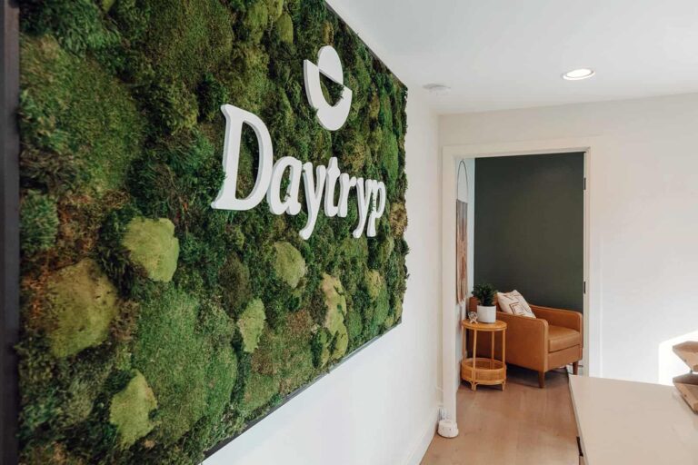 Daytryp logo displayed on a moss wall in a therapy center.